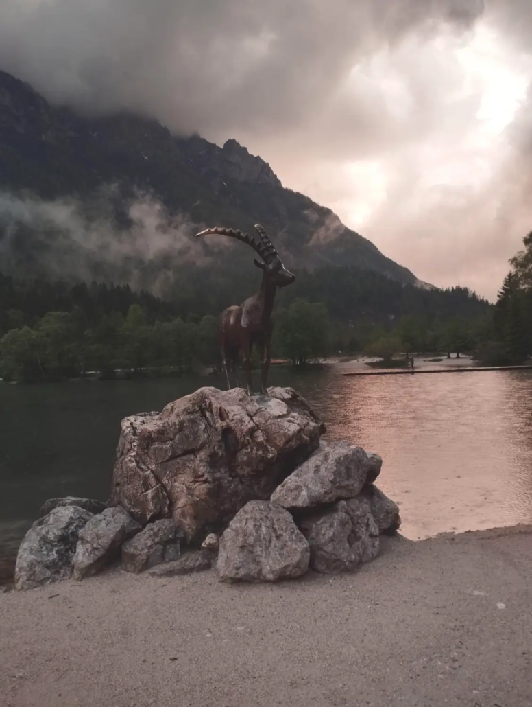 click and book slovenia trip lake picture with statue